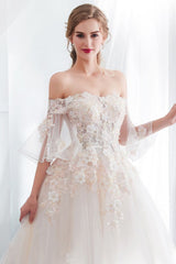 Check this Ball Gown Off-the-shoulder Floor Length Appliques Tulle Wedding Dresses at stylesnuggle.com, this dress will make your guests say wow. The Off-the-shoulder bodice is thoughtfully lined, and the Floor-length skirt with Appliques to provide the airy, flatter look of Satin,Tulle.