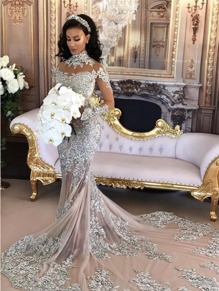 Wanna get a dress in Mermaid style, and delicate Lace,Crystal work? stylesnuggle custom made you this Classic High neck Long Sleevess Mermaid Wedding Dress Silver Tulle Bridal Gowns with Lace Appliques at factory price.