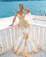 stylesnuggle offers Mermaid Bridal Gowns Gold Appliques Half Sleeve Cape at a good price, 1000+ options, fast delivery worldwide.