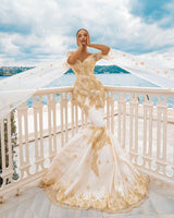 stylesnuggle offers Mermaid Bridal Gowns Gold Appliques Half Sleeve Cape at a good price, 1000+ options, fast delivery worldwide.