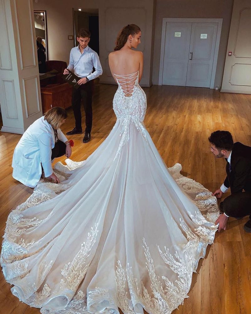 Inspired by this wedding dress at stylesnuggle.com,Mermaid style, and Amazing Lace work? We meet all your need with this Classic Modern Strapless Mermaid Puffy Appliques Bridal Bridal Gowns.