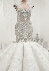 Inspired by this wedding dress at stylesnuggle.com,Mermaid style, and Amazing Crystal work? We meet all your need with this Classic latest V Neck Cap Sleeve Beads Crystals Mermaid Wedding Dress Lace Applique.