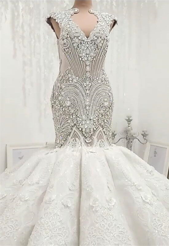 Inspired by this wedding dress at stylesnuggle.com,Mermaid style, and Amazing Crystal work? We meet all your need with this Classic latest V Neck Cap Sleeve Beads Crystals Mermaid Wedding Dress Lace Applique.