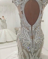 Inspired by this wedding dress at stylesnuggle.com,Mermaid style, and Amazing Crystal work? We meet all your need with this Classic latest V Neck Cap Sleeve Beads Crystals Mermaid Wedding Dress Lace Applique.