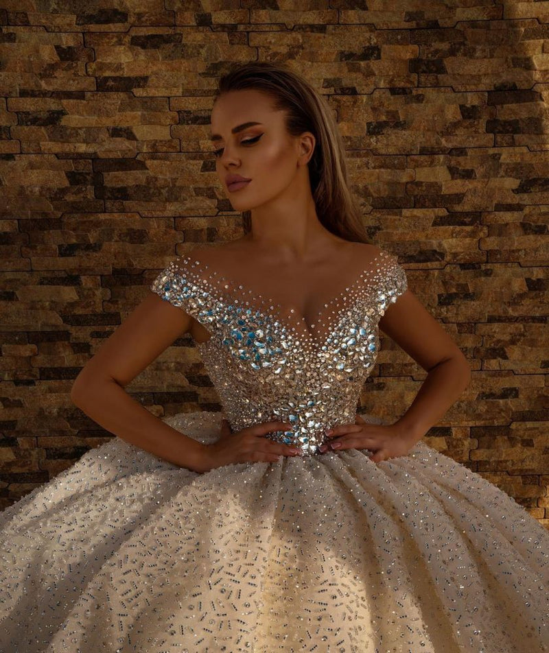 Looking for a dress in Satin, A-line style, and AmazingSequined,Rhinestone work? We meet all your need with this Classic Off the Shoulder Crystal Princess Ball Gown Sequins Bridal Gowns.