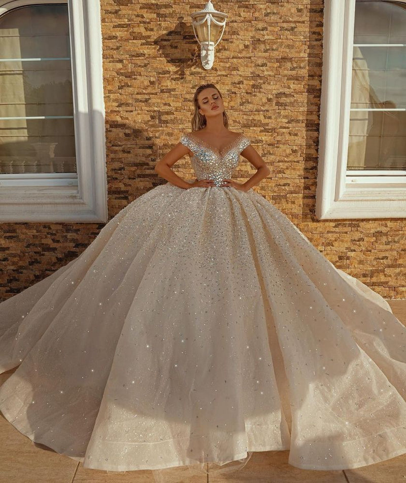 Looking for a dress in Satin, A-line style, and AmazingSequined,Rhinestone work? We meet all your need with this Classic Off the Shoulder Crystal Princess Ball Gown Sequins Bridal Gowns.