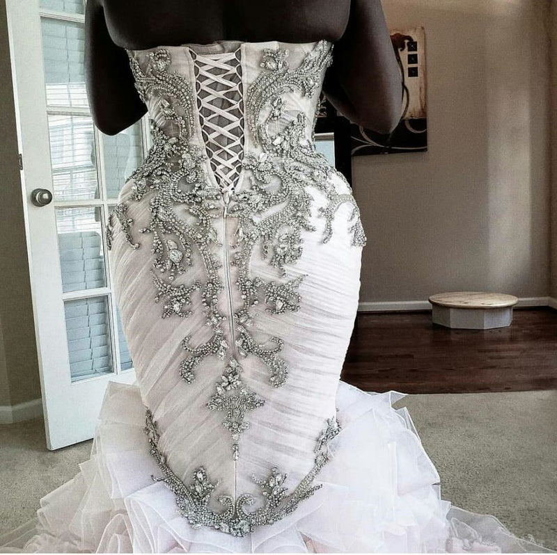 stylesnuggle offers Plus Size Mermaid Crystal Lace Beads Sweetheart Long Train African Custom Made Ruffless Wedding Dresses online at an affordable price from Satin,Taffeta,Hard Net to Ball Gown Floor-length skirts. Shop for Amazing Sleeveless wedding collections for your big day.