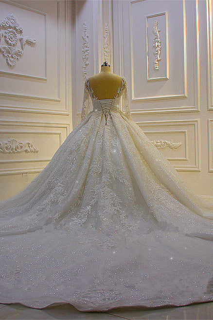 Finding a dress in Tulle, Ball Gown style, and delicate Lace,Beading,Appliques work? stylesnuggle custom made you this Sparkle 3D Lace Appliques Long Sleevess Church Train Wedding Dress at factory price.