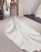 Looking for a dress in Tulle,Lace, Mermaid style, and Amazing Lace work? stylesnuggle custom made you this White Illusion neck White Sleeveless Mermaid Wedding Dress with Overskirt.